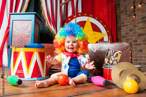 Little baby clown with red nose multi-colored wig in with balls photo