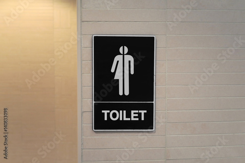 Gender neutral restroom sign that says, TOILET