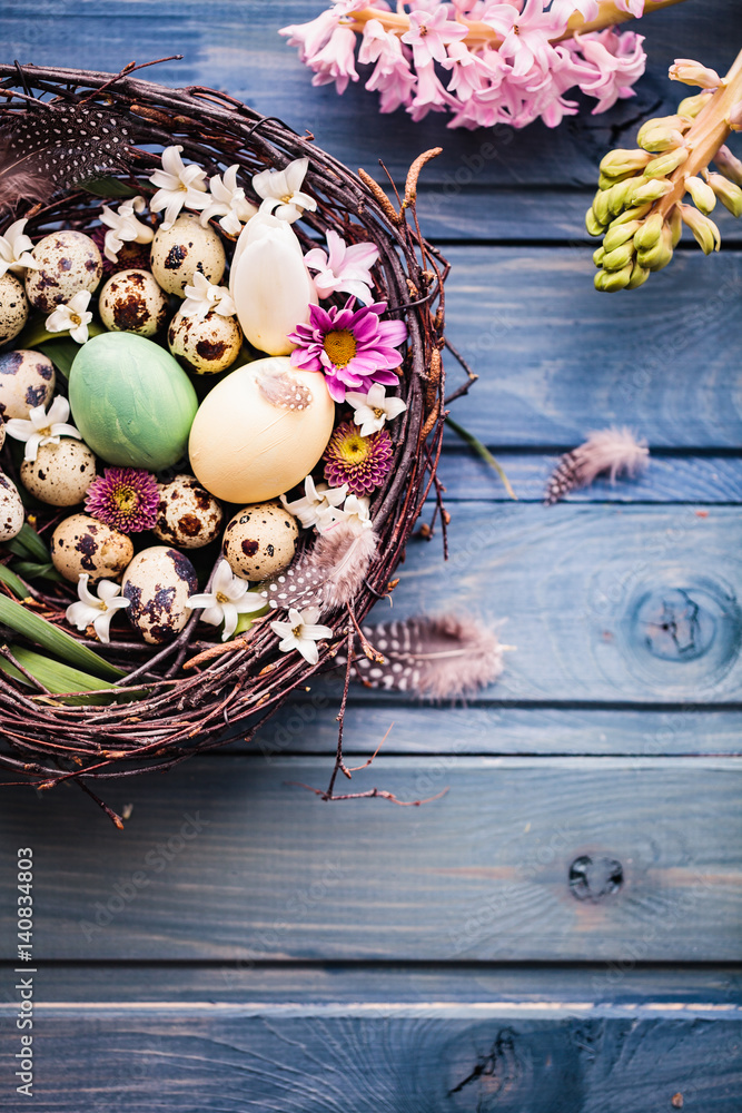 Nest with easter eggs on a blue wooden background Nest with easter eggs on a blue wooden background