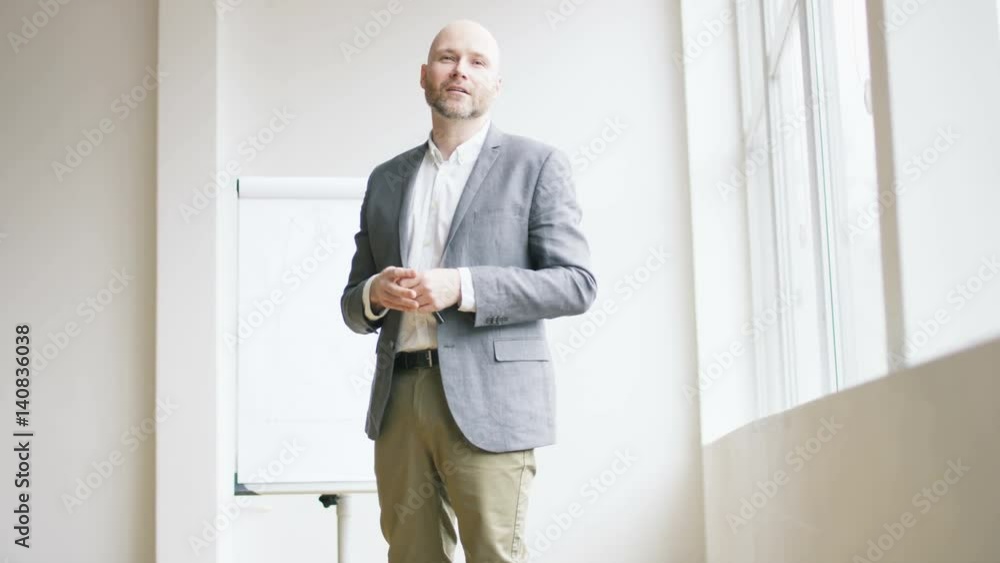 Bald Businessman Pointing With a Marker Bald Businessman Pointing With a Marker