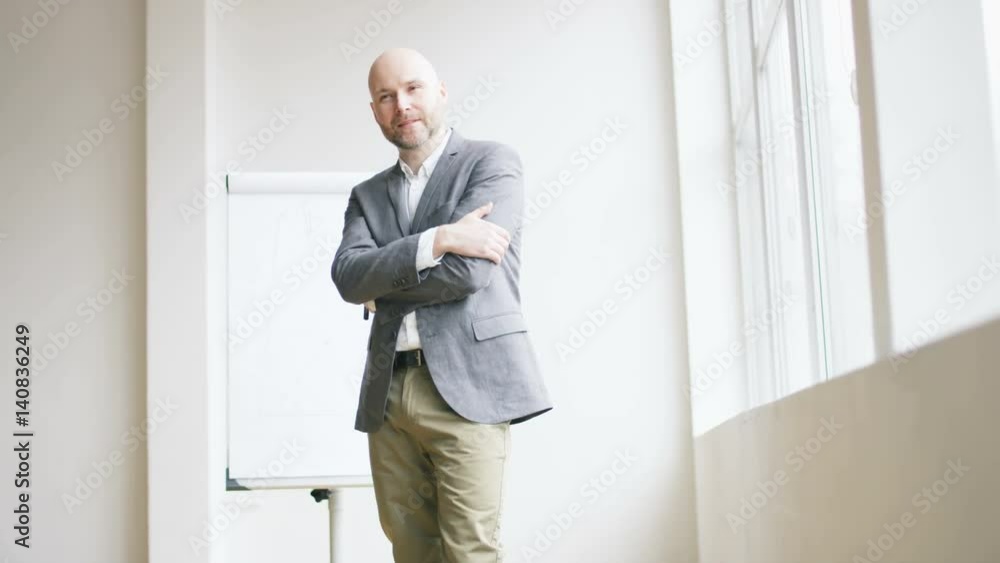 Bald Businessman Pointing With a Marker Bald Businessman Pointing With a Marker