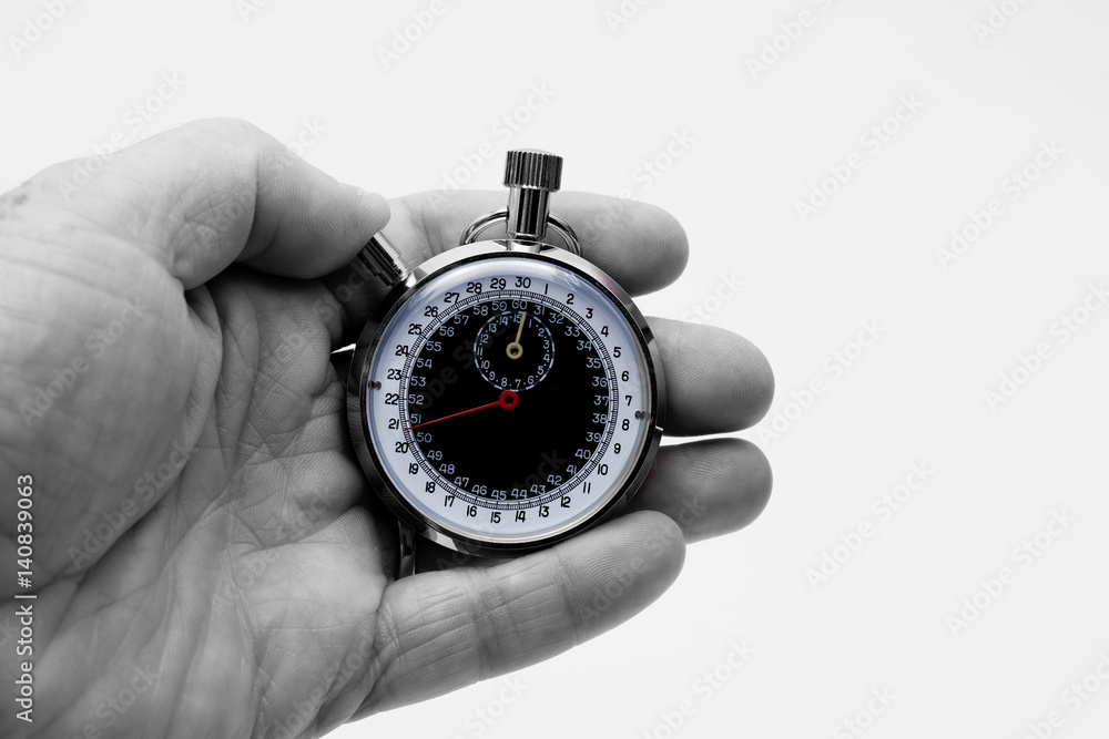 Stopwatch in palm of hand black and white Stopwatch in palm of hand black and white