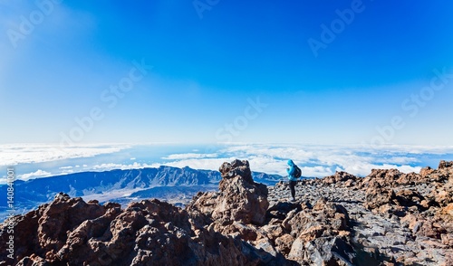 Woman using phone on the top of Teide volcano