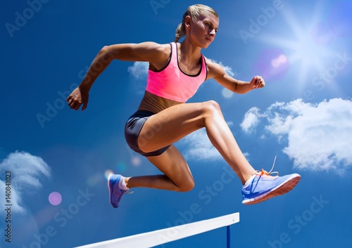 Female athlete jumping above the hurdle © vectorfusionart