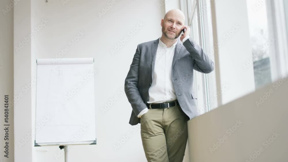 Bald Businessman Having a Nice Phone Call Bald Businessman Having a Nice Phone Call