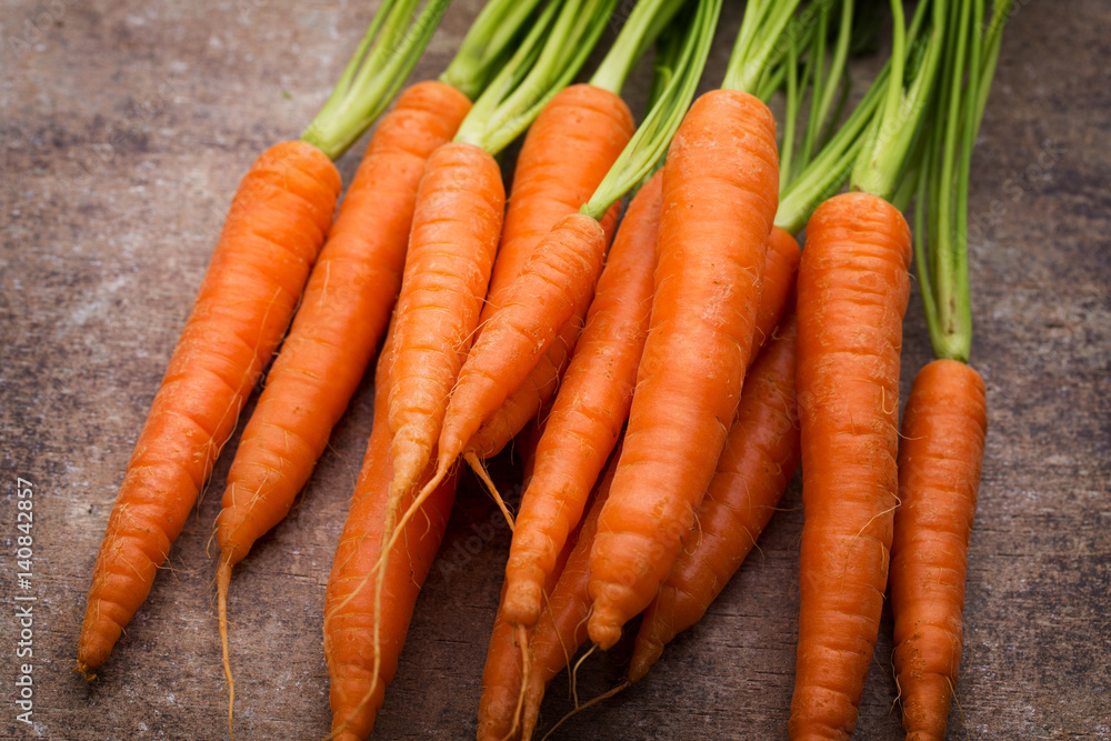 Fresh and sweet carrot on a grey wooden table. Fresh and sweet carrot on a grey wooden table.