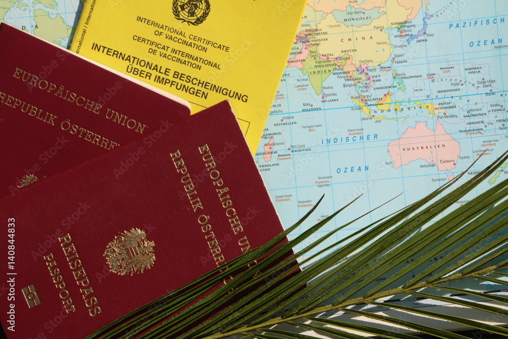 World Travel, Entry Requirements, Weltreisen, Einreisebestimmungen; 2 EU-Reisepässe neben einem Impfausweis auf einer Weltkarte, daneben ein Palmwedel
