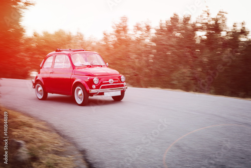 Fotografie Small vintage car on the road