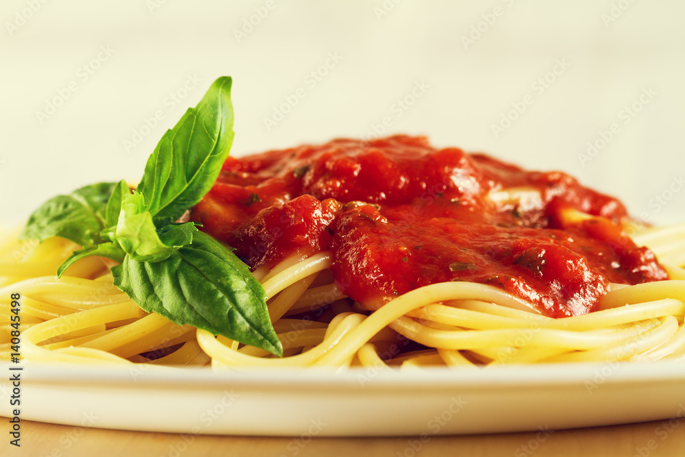 Tasty colorful appetizing cooked spaghetti italian pasta with tomato sauce bolognese and fresh basil. Closeup. Toning. Tasty colorful appetizing cooked spaghetti italian pasta with tomato sauce bolognese and fresh basil. Closeup. Toning.