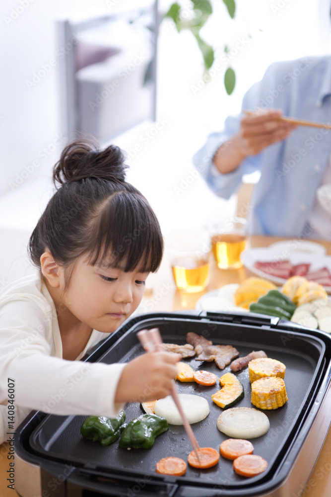 Girl Taking Vegetable From Grill Girl Taking Vegetable From Grill