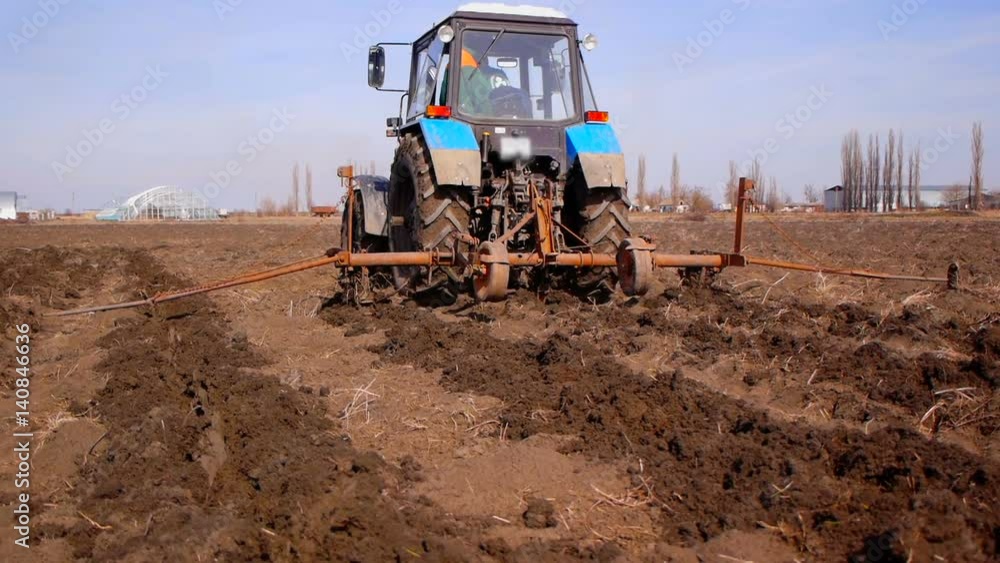 Plowing fields with a tractor. Cultivation of soil Plowing fields with a tractor. Cultivation of soil