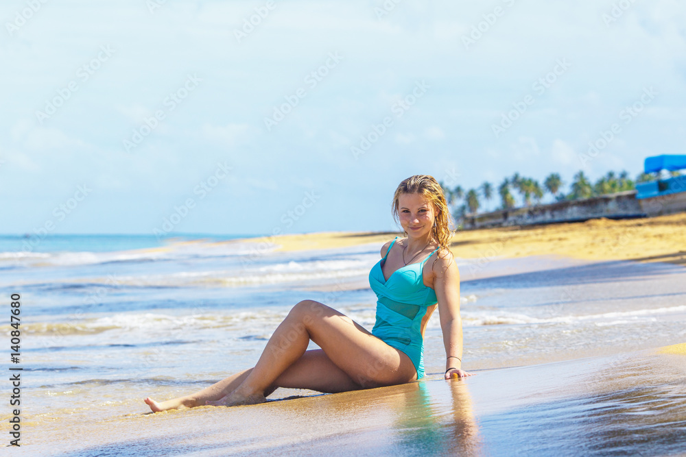 Girl model sitting on the tropical beach