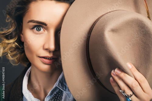 Close up portrait of beautiful woman in hat,bohho style,beauty make up,amazing bohho look,Rings,decorations on the girl,great details,curly hair,denim shirt,red lips,European in hat,Well-groomed skin photo