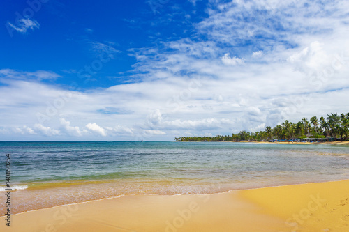 sea surf on the beach. Sand, sea, blue sky and white clouds