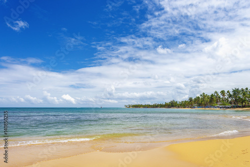 sea surf on the beach. Sand, sea, blue sky and white clouds