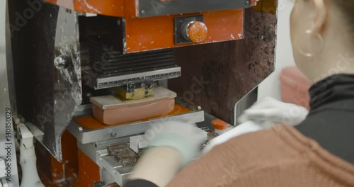 Worker operates Label Pad Printing machine