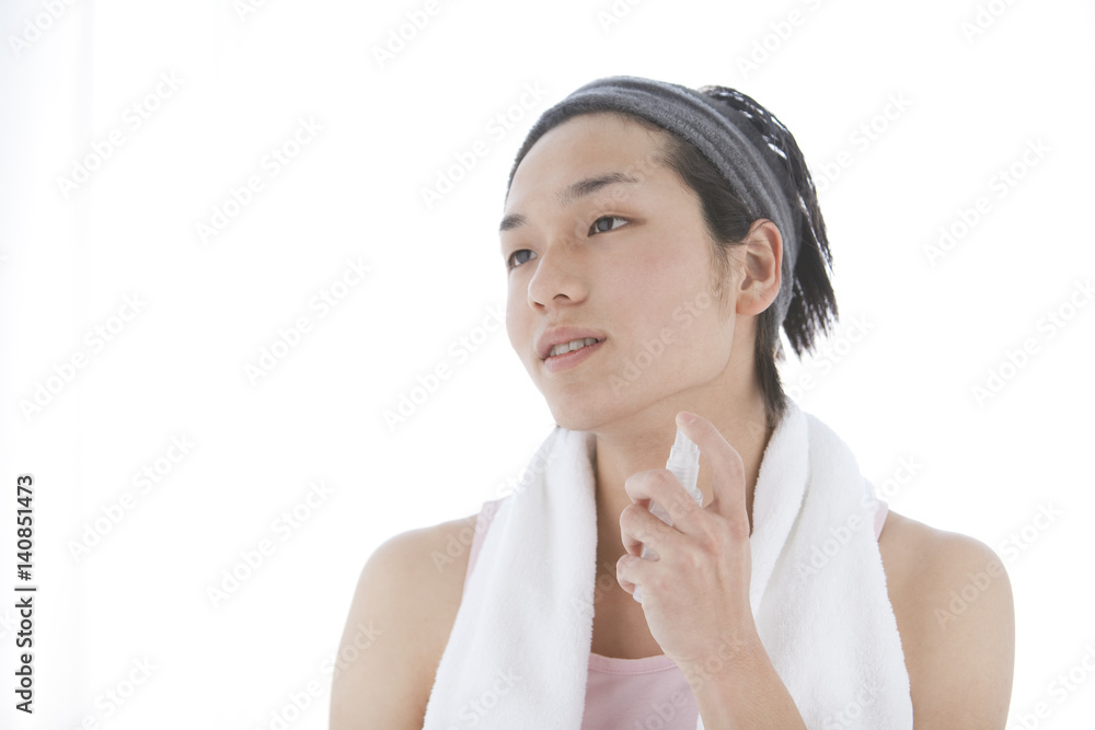 Young Man with Headband Using Skincare Product Young Man with Headband Using Skincare Product
