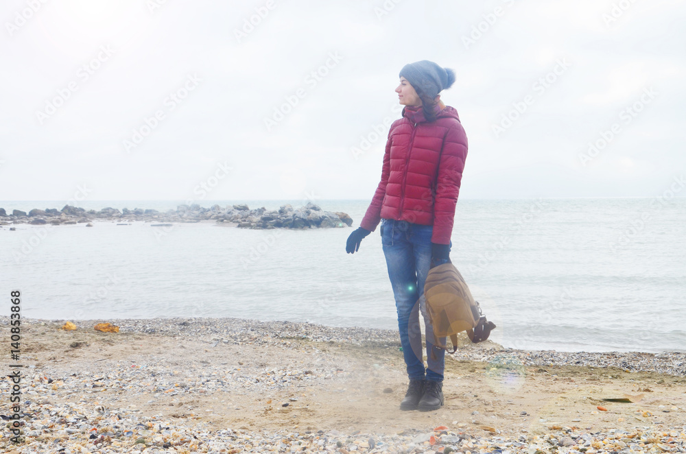 Young woman near the sea in cold weather