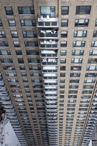 Column of snow covered balconies on Manhattan high-rise after snowstorm Stella