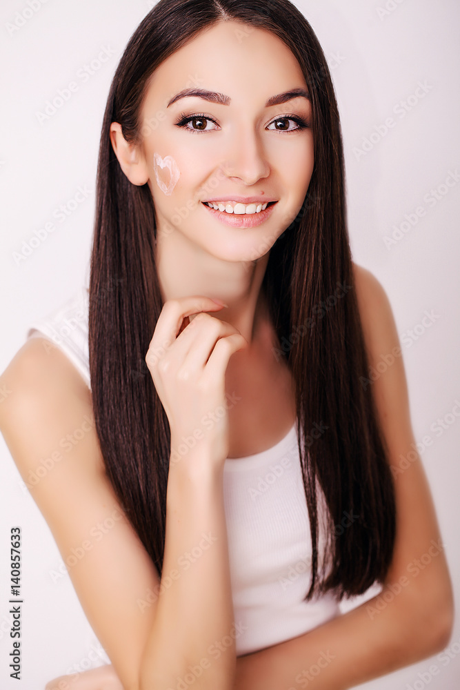 Beautiful Young Woman with Clean Fresh Skin touch her face . Facial treatment . Cosmetology , beauty and spa . Beautiful Young Woman with Clean Fresh Skin touch her face . Facial treatment . Cosmetology , beauty and spa .