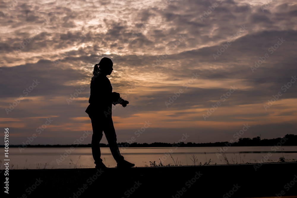 Fototapeta premium Man show hands silhouette sunset background