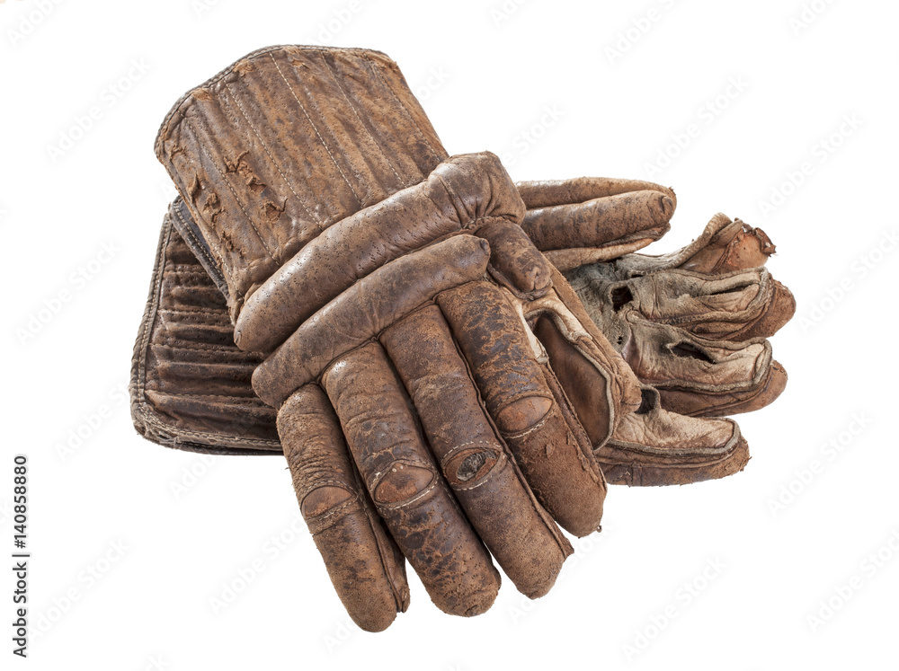 Obraz premium A pair of worn leather hockey gloves isolated on a white background.