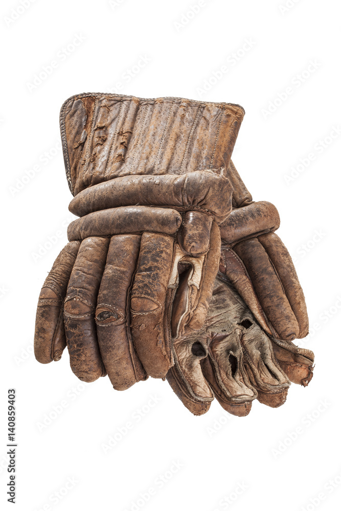 Naklejka premium A pair of worn leather hockey gloves isolated on a white background.