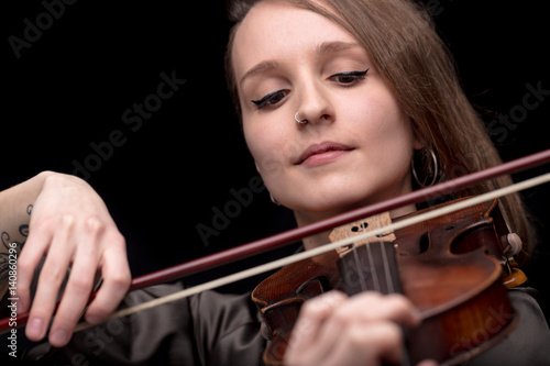 violinist woman with a nose piercing playing