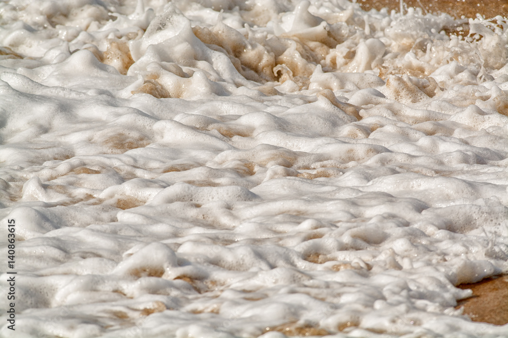 water breaking on sand background water breaking on sand background