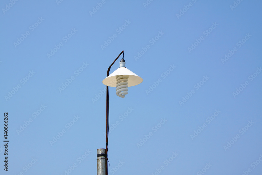 Classic street lamp against blue sky . Classic street lamp against blue sky .