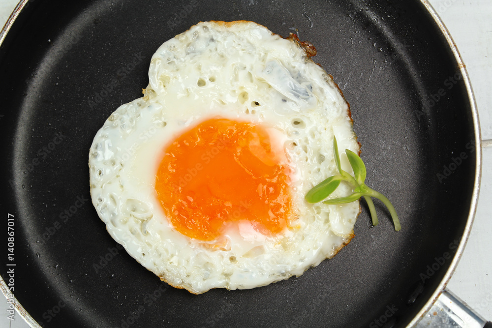 fried egg heart-shaped for breakfast on plate fried egg heart-shaped for breakfast on plate