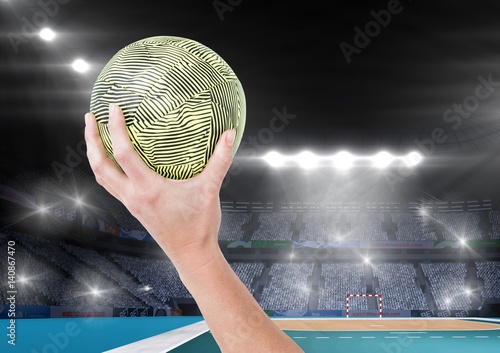 Close-up of hand holding ball and stadium in background