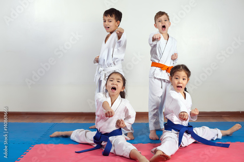 Four children demonstrate martial arts working together