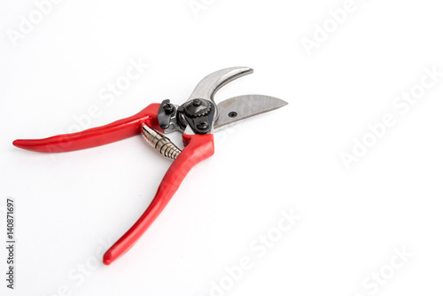 Red garden pruner on the white background
