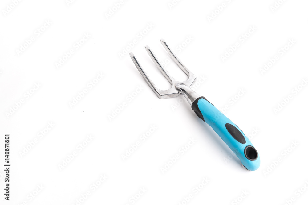 Small garden tool. Rake, used to loosen the soil Small garden tool. Rake, used to loosen the soil