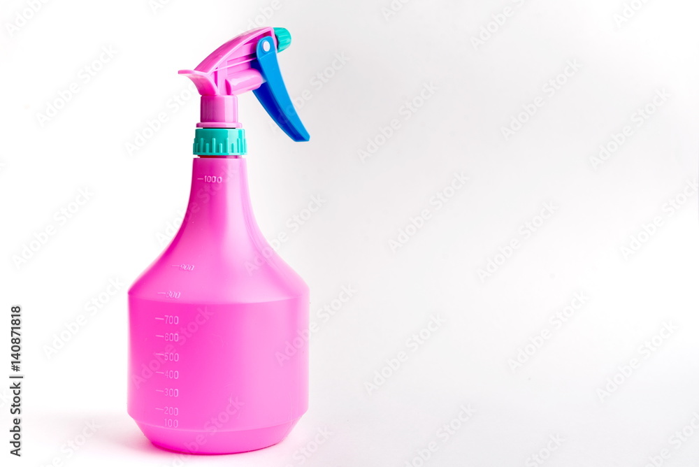 Small liquid atomizer of different colors on a white background, lilac. sprayer Small liquid atomizer of different colors on a white background, lilac. sprayer