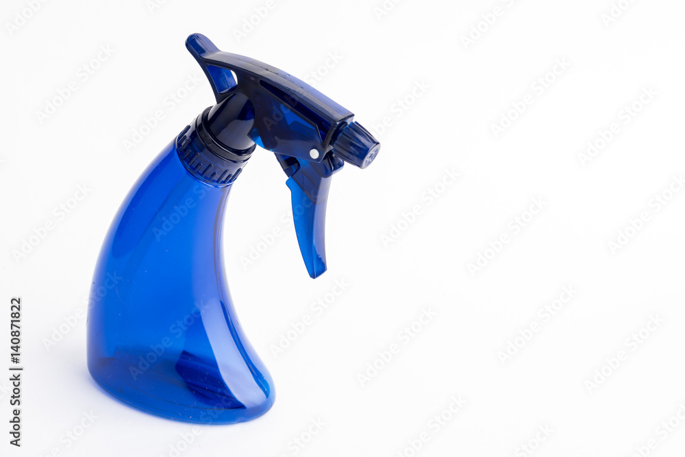 Small liquid atomizer of different colors on a white background, blue sprayer Small liquid atomizer of different colors on a white background, blue sprayer