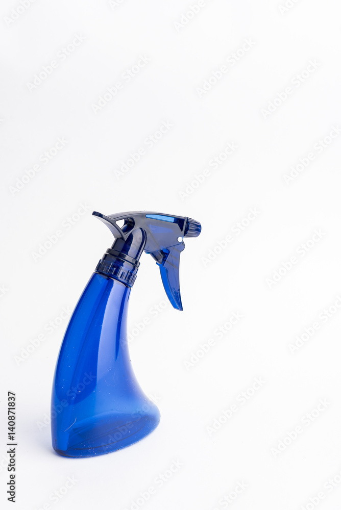 Small liquid atomizer of different colors on a white background, blue sprayer Small liquid atomizer of different colors on a white background, blue sprayer