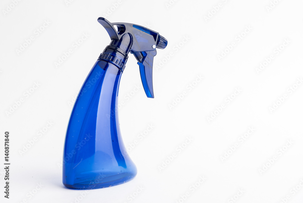 Small liquid atomizer of different colors on a white background, blue sprayer Small liquid atomizer of different colors on a white background, blue sprayer