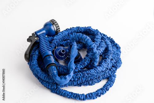 The hose of a garden hose of blue color, made of modern materials, can grow in size, stretchable