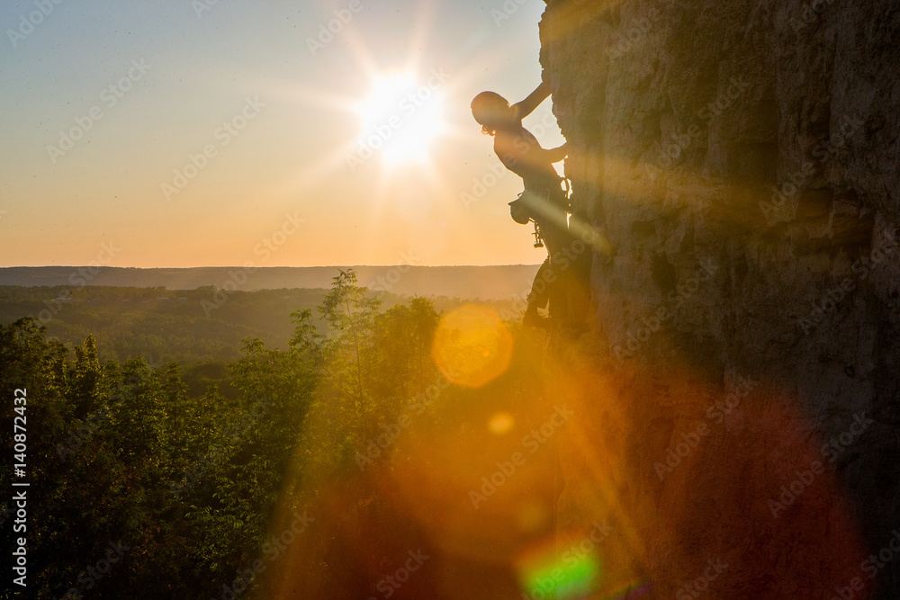 Silhouette of a Woman rock climbing on Ontario's Niagara Escarpment in Canada