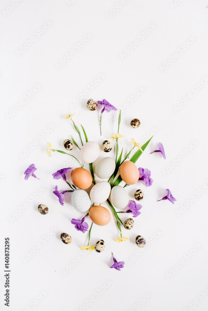 Brown and white Easter eggs, quail eggs, yellow and purple flowers on white background. Flat lay, top view. Traditional spring concept. Easter concept. Brown and white Easter eggs, quail eggs, yellow and purple flowers on white background. Flat lay, top view. Traditional spring concept. Easter concept.