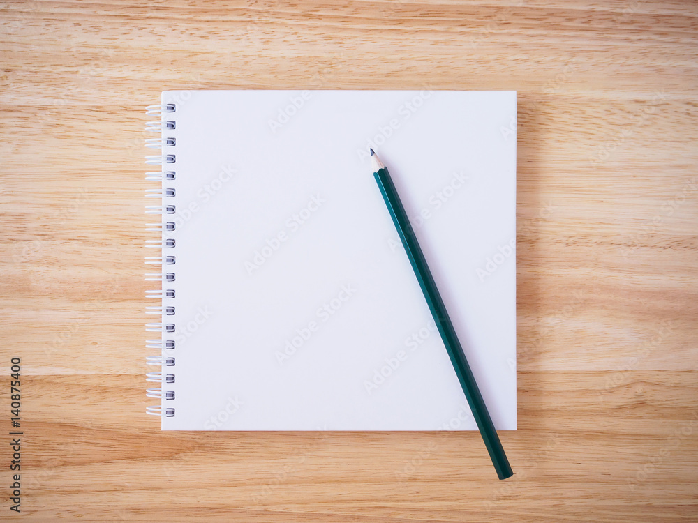 white cover notebook top view with pencil on brown wood desk white cover notebook top view with pencil on brown wood desk