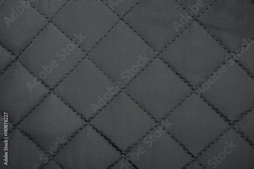 Quilted synthetic fabric texture background.