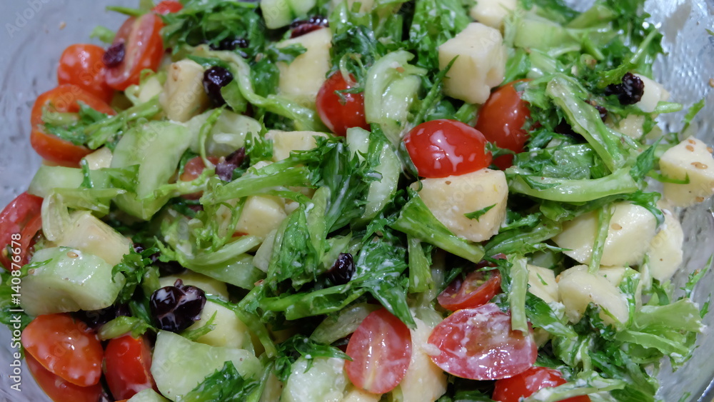 Salad with green leaves, tomatoes, cucumbers and apple Salad with green leaves, tomatoes, cucumbers and apple