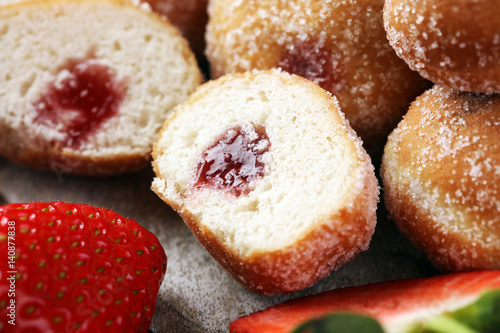 Bomboloni - traditional Italian doughnuts stuffed with strawberry jam