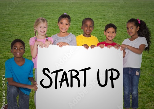 Portrait of kids standing with placard with start up text 