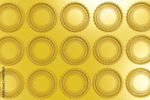 Pattern of concentric shapes made of rings and spirals on yellow background