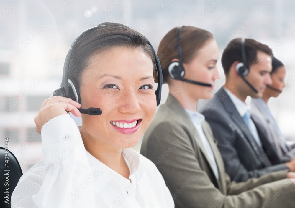 Portrait of happy woman talking on headset in call centre Portrait of happy woman talking on headset in call centre