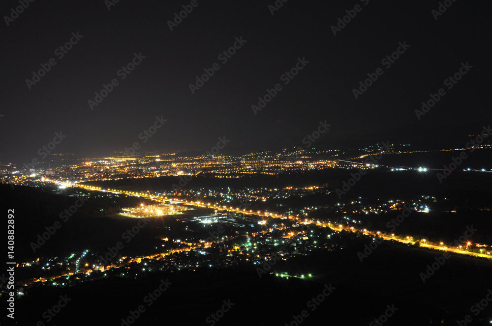 Naklejka premium City lights in the night, Nis, Serbia at night view on the city from the hill at night.